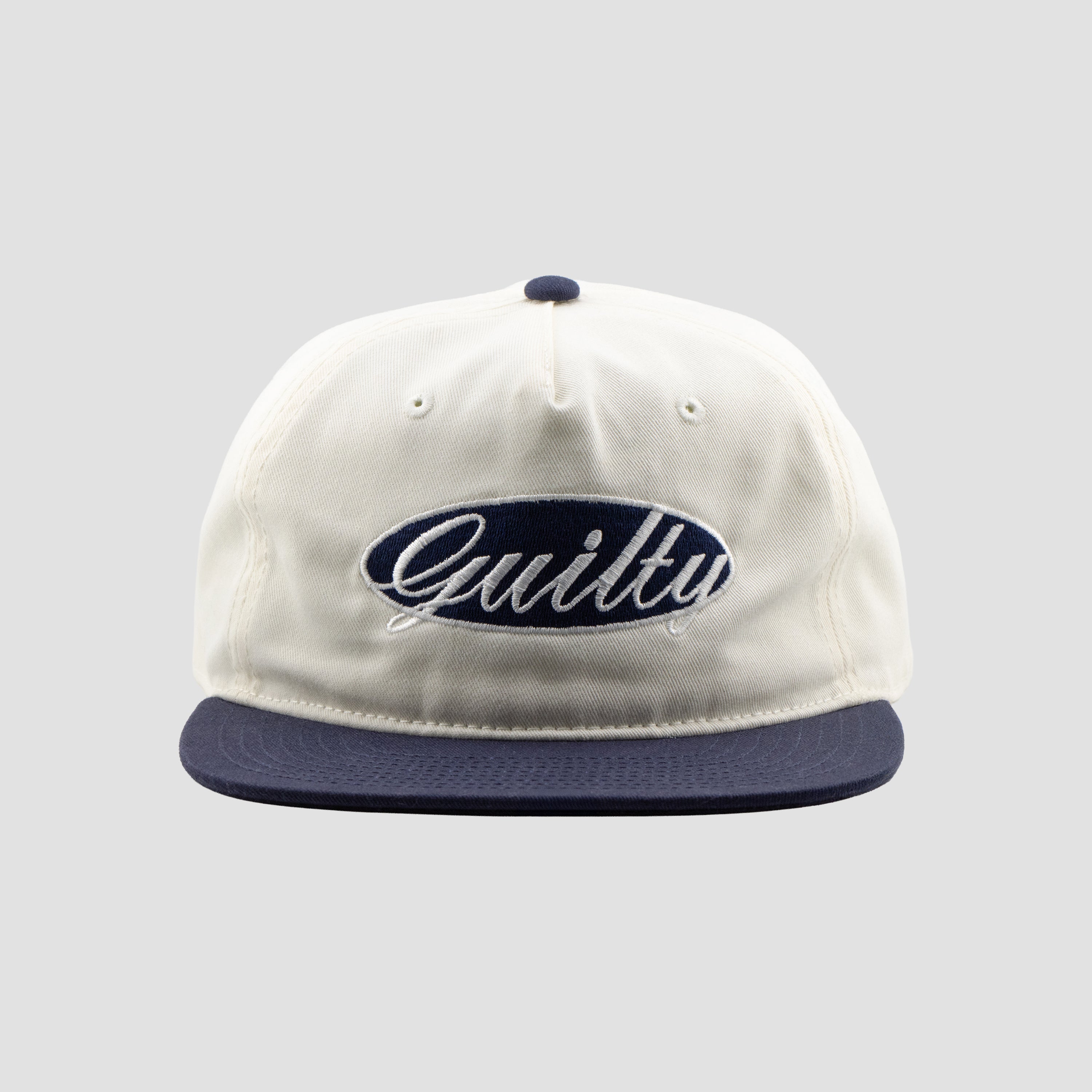 White cap with 'Guilty' logo on a gray background